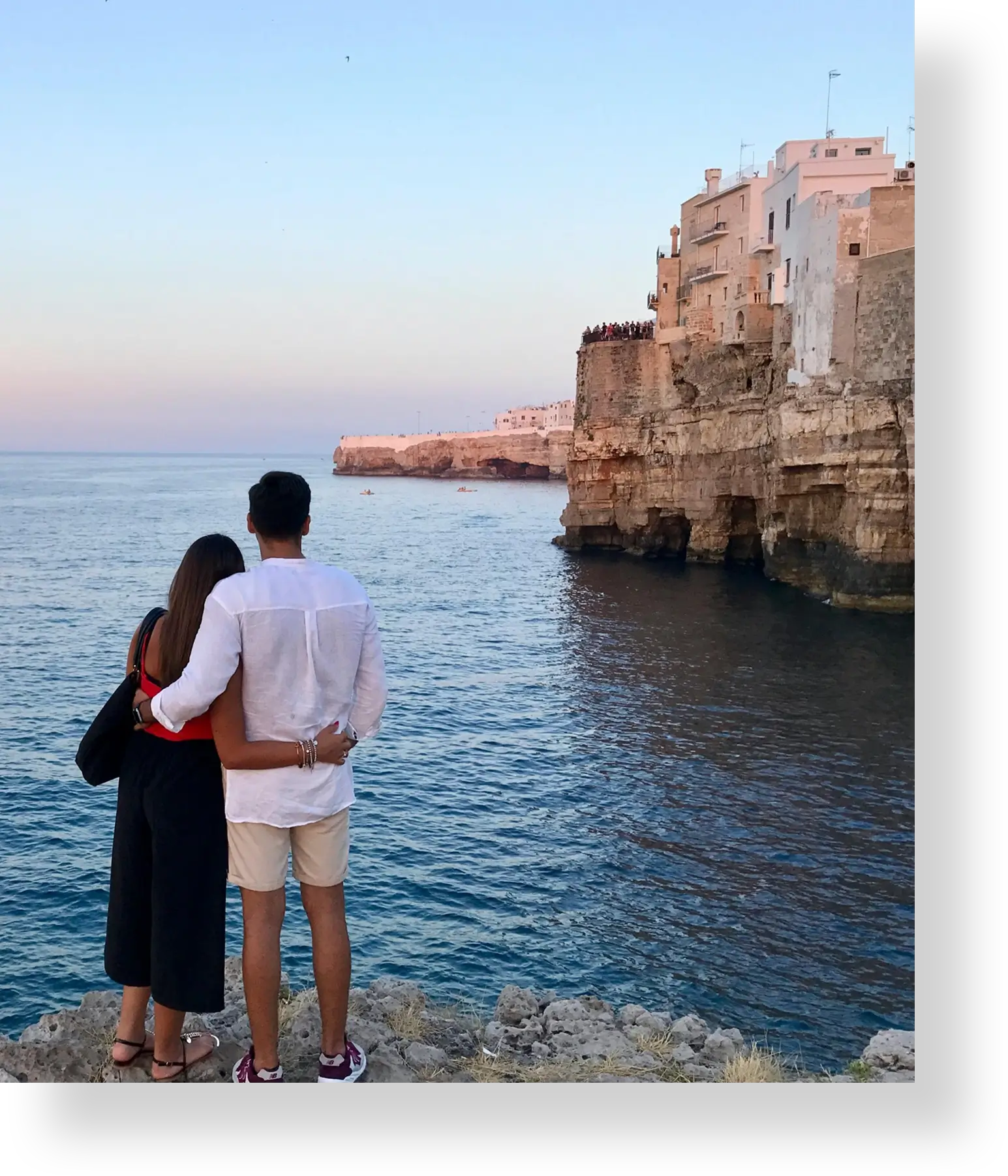 Couple overlooking coastal city by the sea.