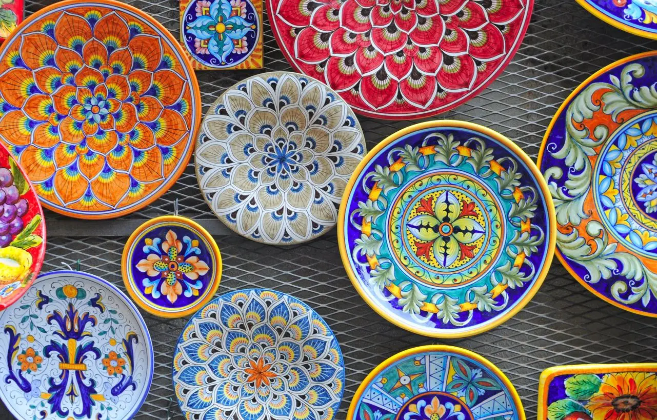 Colorful patterned ceramic plates on display.